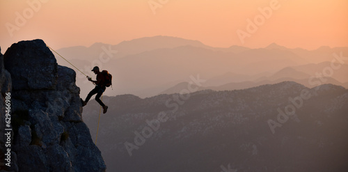 Young Man's Difficult Rock Climb