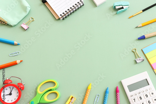 Back to school concept on pastel green background. Top view