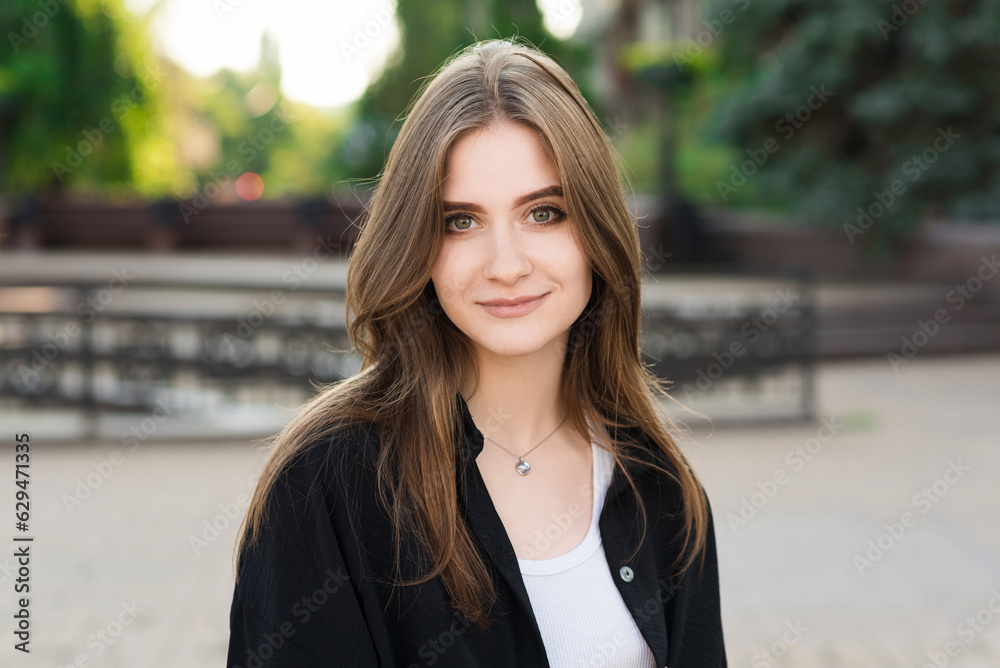 Portrait of a young and attractive happy girl in casual clothes on a summer day. Portrait of a young and attractive happy girl in casual clothes on a summer day.