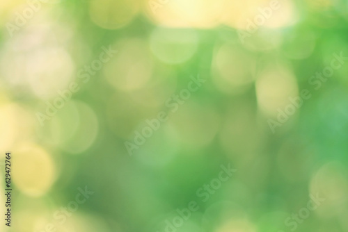 Green bokeh abstract, pattern of blurred bright light in natural background.