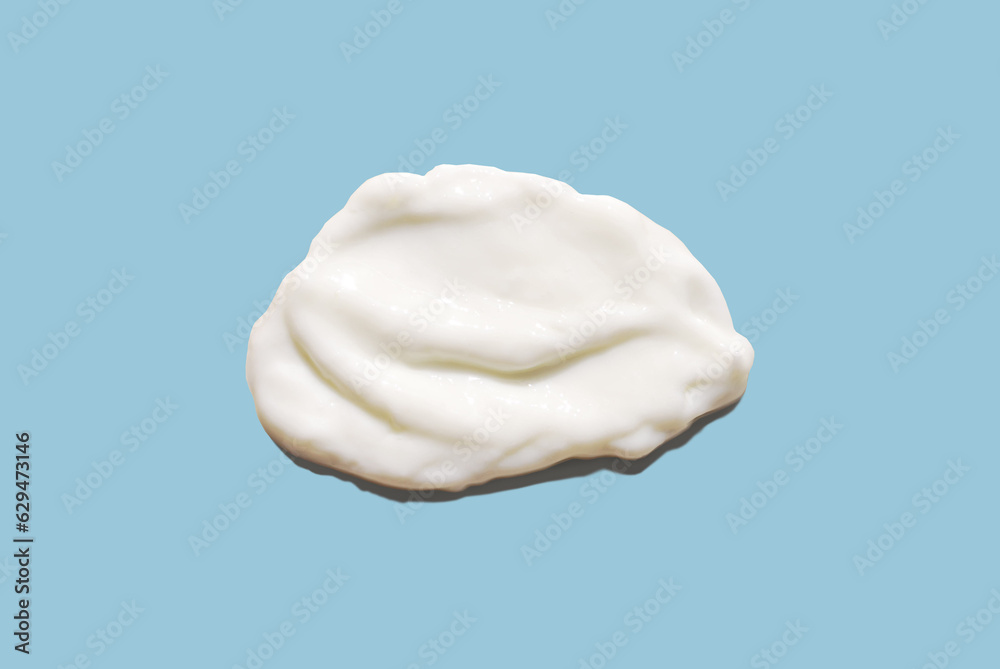 White сosmetic smear of creamy texture on a blue background. Cream mockup. Natural skin care concept White сosmetic smear of creamy texture on a blue background. Cream mockup. Natural skin care concept