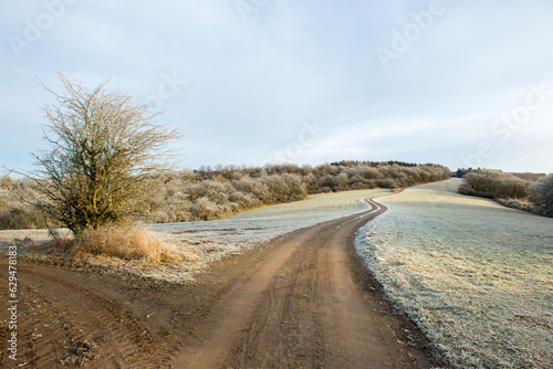 Frosty road in the mountains and meadows