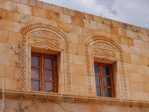 travel to city of Lindos on island of Rhodes, Greece. Details of streets of old town Lindos. Interesting elements of door, shutters, bas-relief of walls. tourist attraction on island of Rhodes