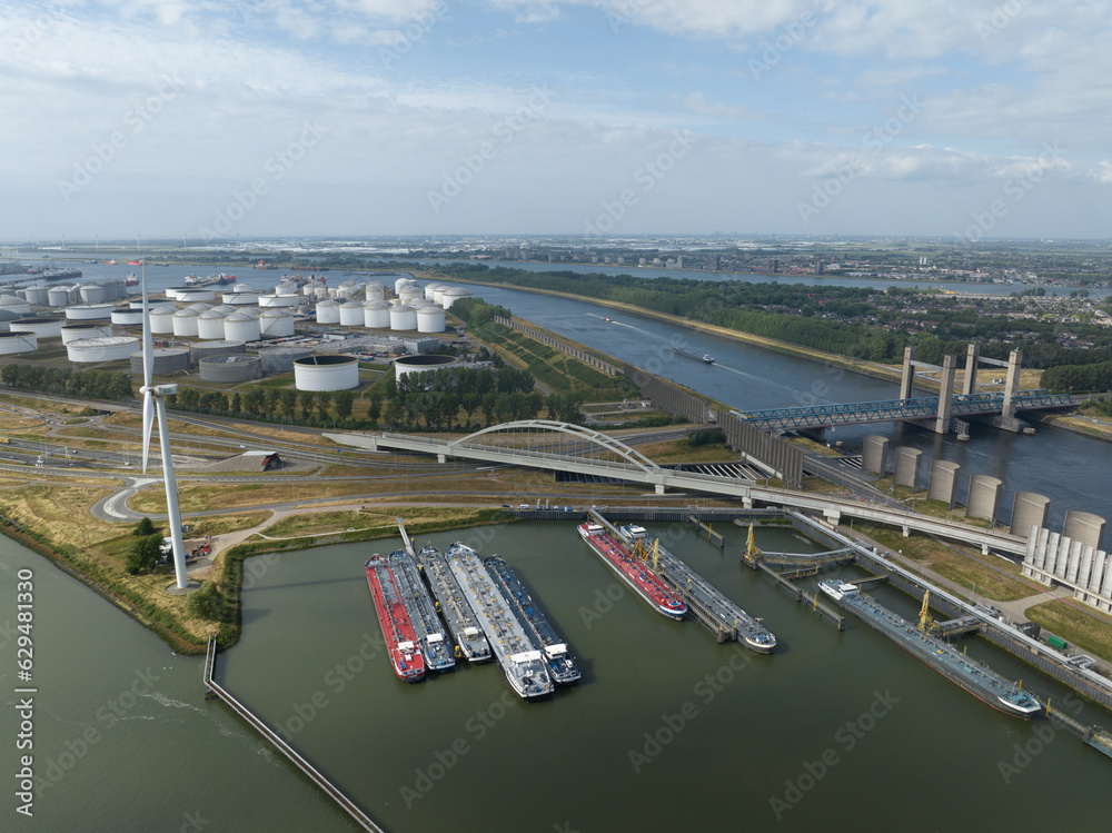 Aerial drone video showcasing the Zwarte Waalseburg at the Theemswegtrac , the Rozenburgsebrug, and the captivating surrounding water and infrastructure.