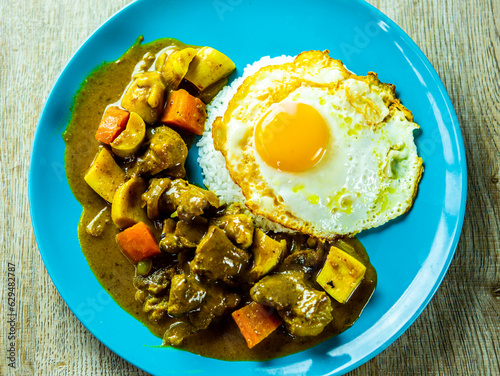 Pork curry with rice and egg in plate, in door  Chiangmai  Thailand.