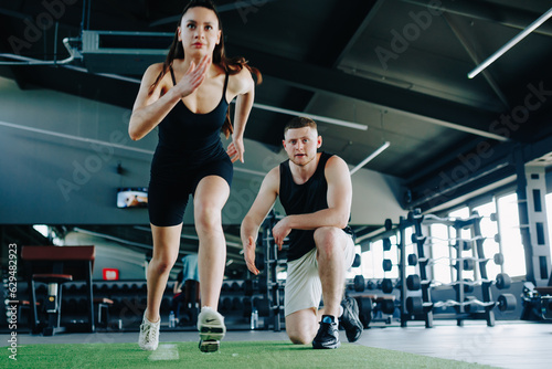 The portrait reveals the genuine interaction between a male personal trainer and a motivated woman, capturing their shared passion for fitness and their commitment to a healthy lifestyle.