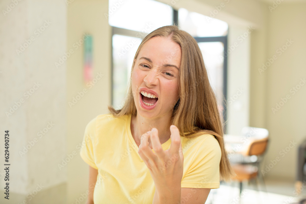pretty blond woman looking angry, annoyed and frustrated screaming wtf or what’s wrong with you pretty blond woman looking angry, annoyed and frustrated screaming wtf or what’s wrong with you
