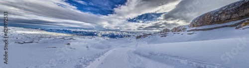 Panoramic image of a ski slope in Ifen ski resort in Kleinwalsertal valley in Austria © Aquarius