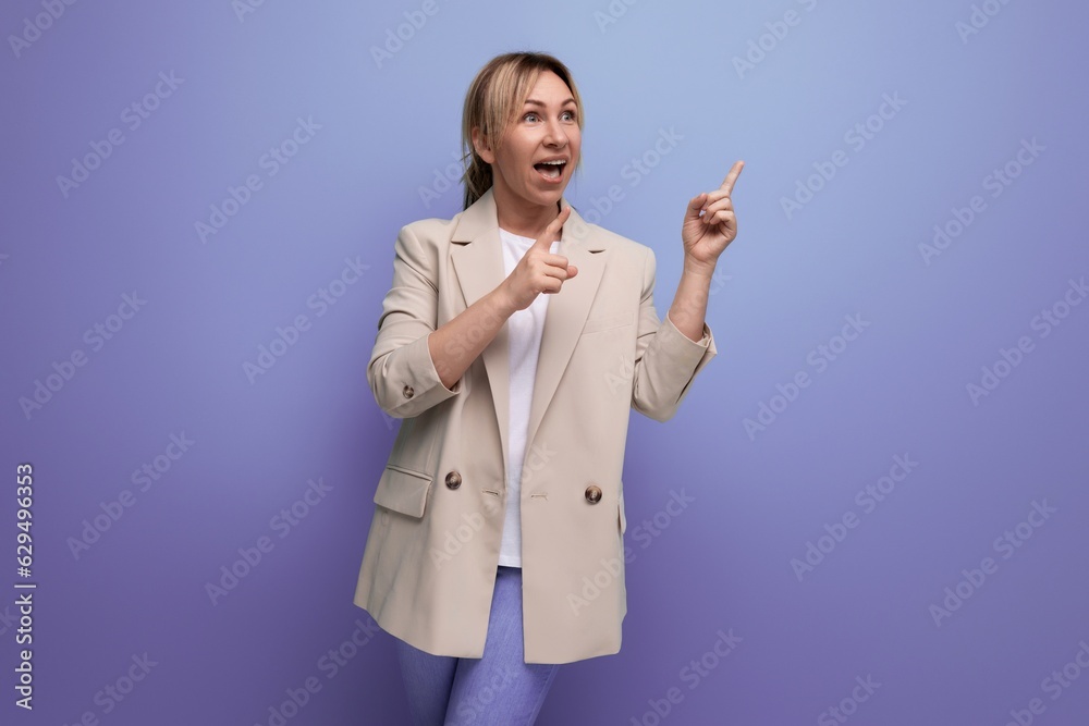 close-up of positive cheerful blonde business woman demonstrating having an idea with hands on blue background with copy space close-up of positive cheerful blonde business woman demonstrating having an idea with hands on blue background with copy space