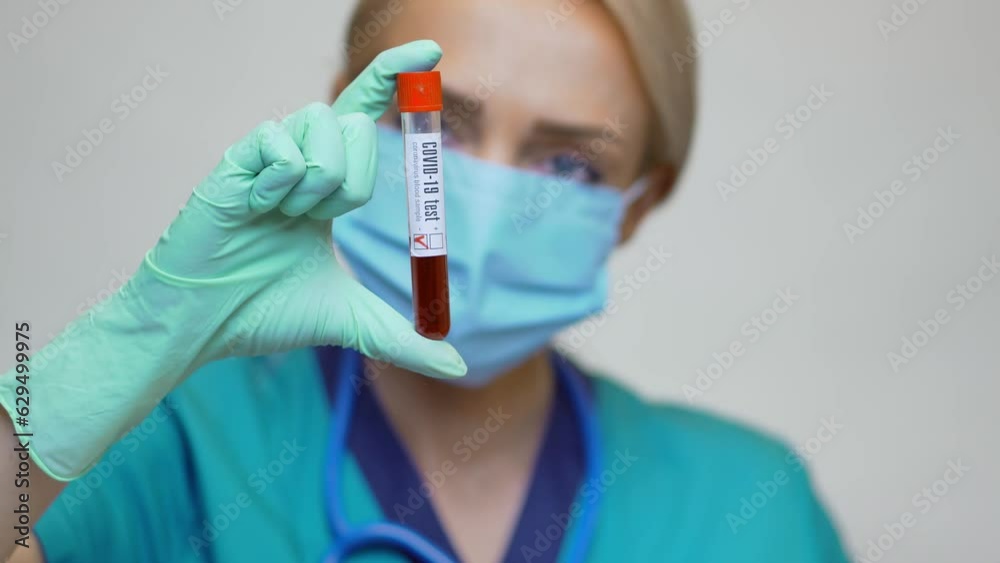 medical doctor nurse woman wearing protective mask and gloves - holding COVID-19 negative blood test medical doctor nurse woman wearing protective mask and gloves - holding COVID-19 negative blood test