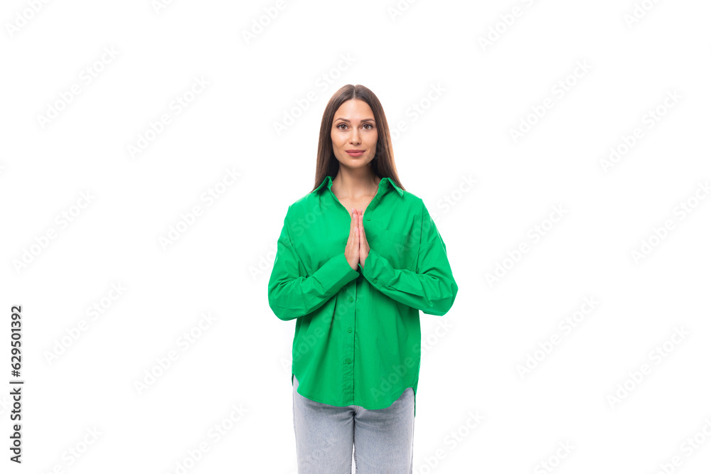 stylish slim young brunette woman with makeup in a green shirt on a white background with copy space stylish slim young brunette woman with makeup in a green shirt on a white background with copy space