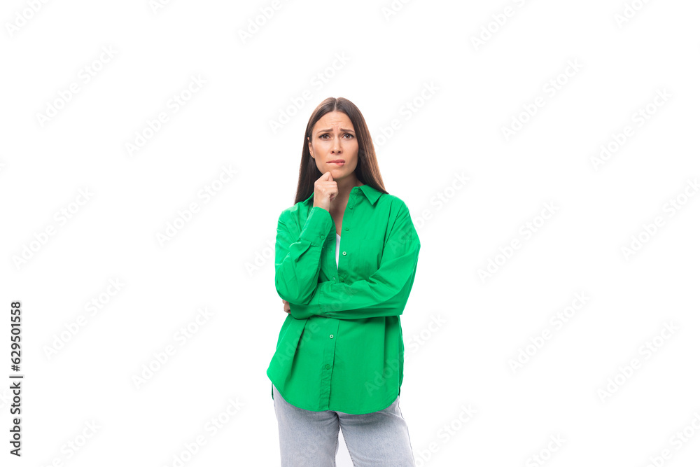 stylish slim young brunette woman with makeup in a green shirt on a white background with copy space stylish slim young brunette woman with makeup in a green shirt on a white background with copy space