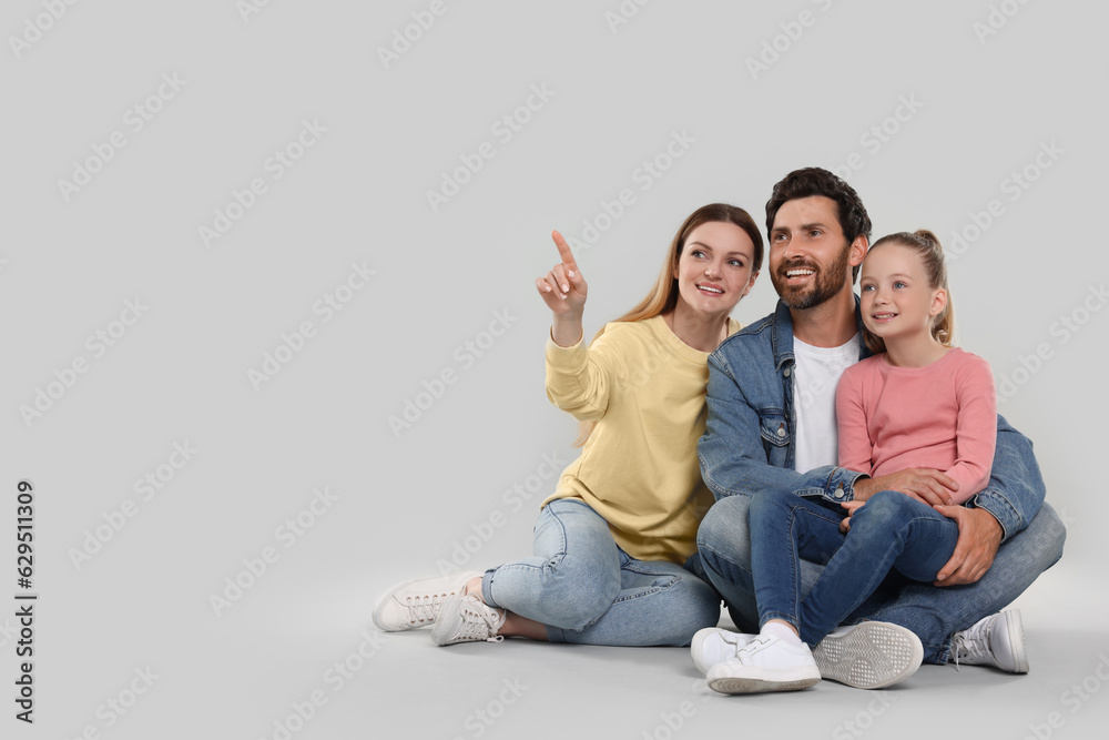 Happy family on light grey background, space for text Happy family on light grey background, space for text