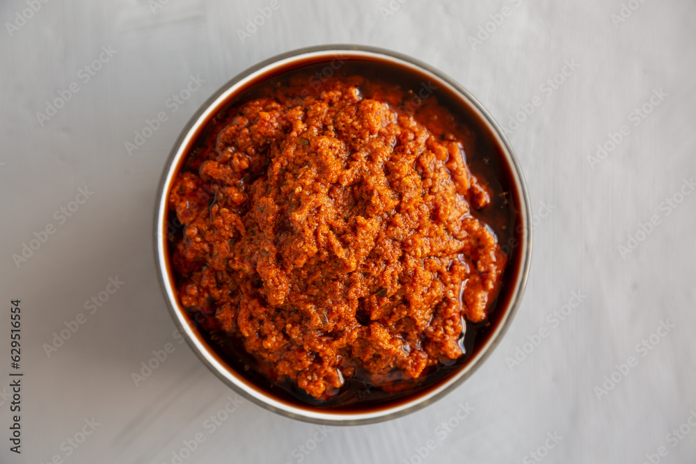 Homemade Sun Dried Tomato Pesto in a Bowl, top view. Flat lay, overhead, from above. Homemade Sun Dried Tomato Pesto in a Bowl, top view. Flat lay, overhead, from above.