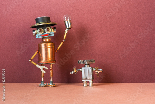 A large adult robot holds a light bulb high in his hand as a symbol of electricity. Little robot child looks at his little light bulb