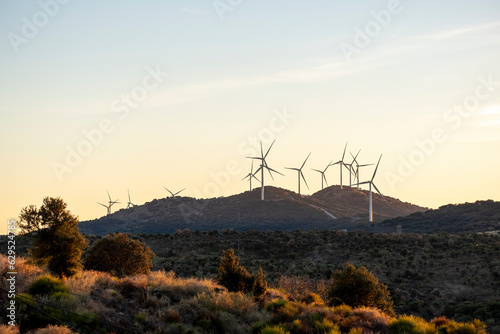 Windmill farm to produce clean energy. Concept idea eco power energy. wind turbine on hill.