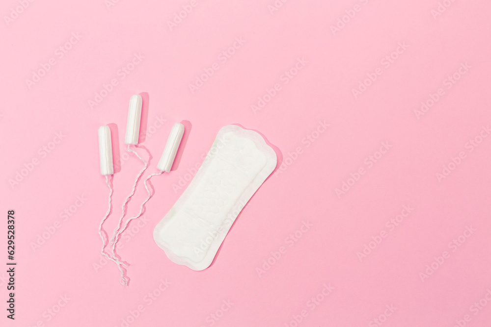 women's tampon and women's pad on pink background women's tampon and women's pad on pink background