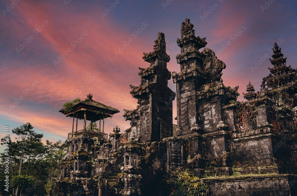 Magnific landscape view of besakih temple with fiery beautiful sky. Sacred balinese temple with traditional architecture