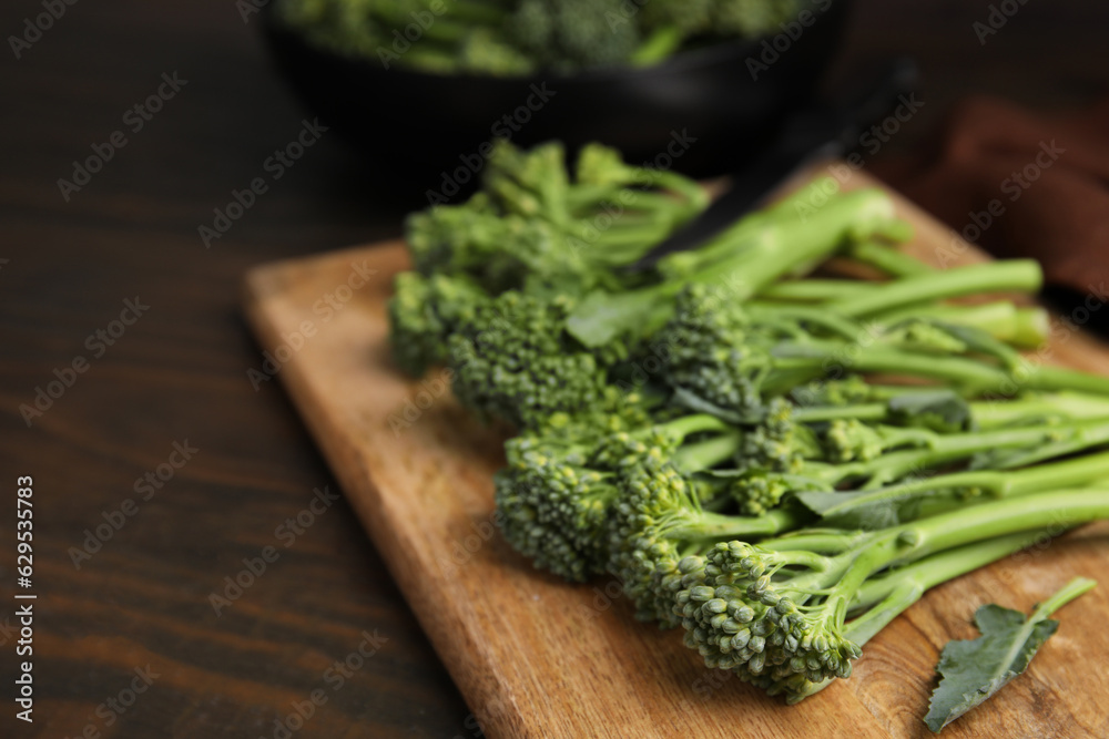 Fresh raw broccolini on wooden table, closeup and space for text. Healthy food Fresh raw broccolini on wooden table, closeup and space for text. Healthy food