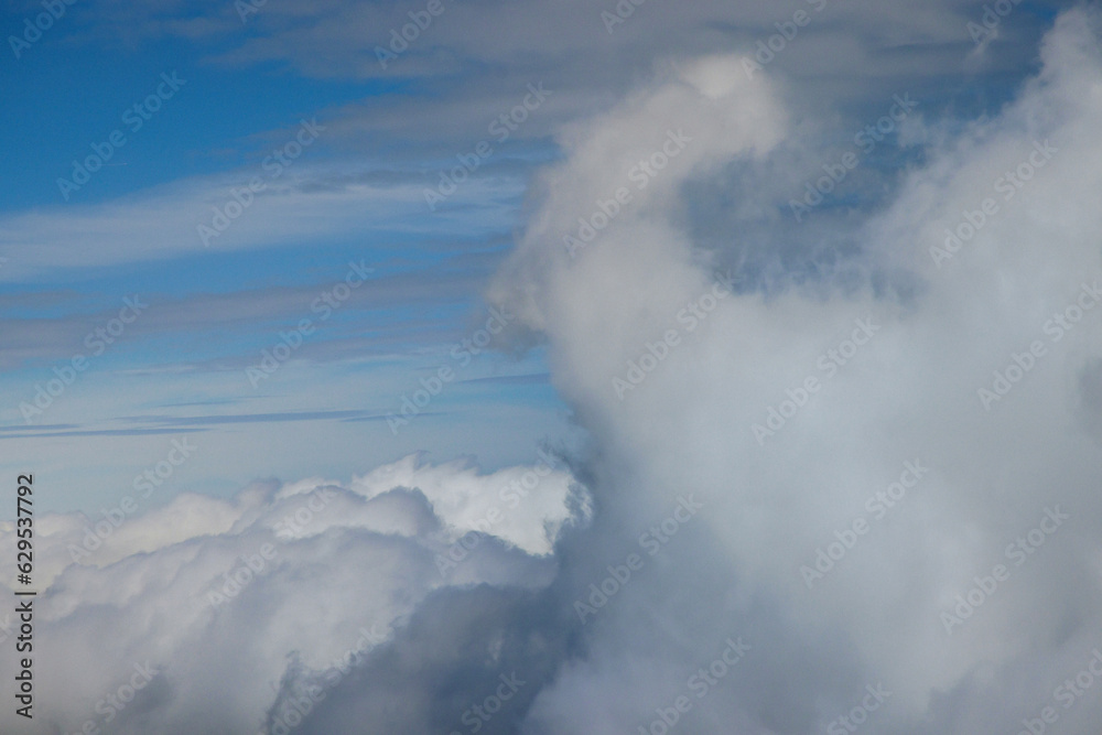 Taking look through window of an aircraft during flight in admiring beautiful blue skies day