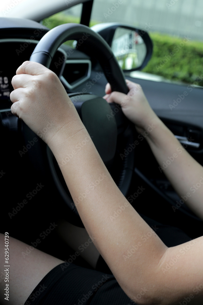 Hands holding steering wheel of car Hands holding steering wheel of car