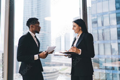 Diverse businesspeople discussing work in modern office