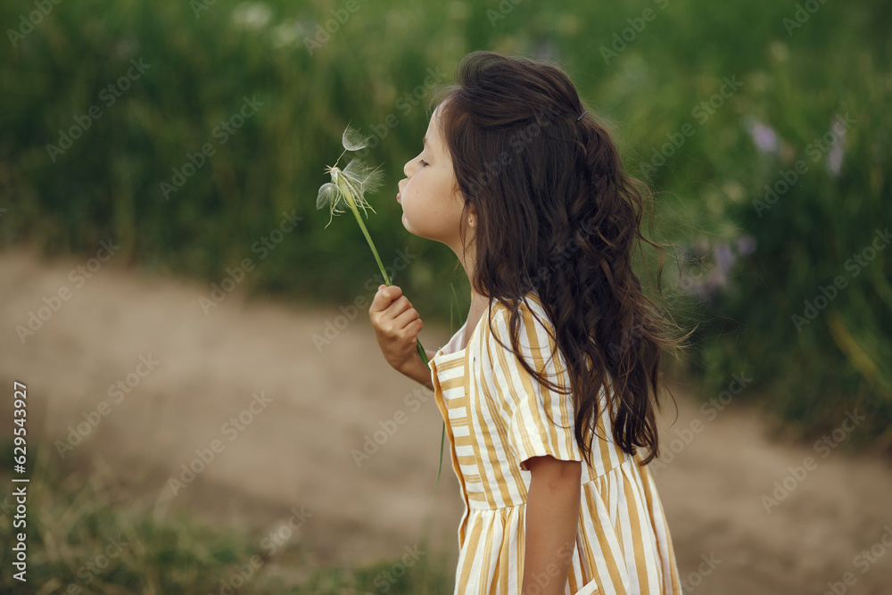 Cute little girl playing in a summer field Cute little girl playing in a summer field