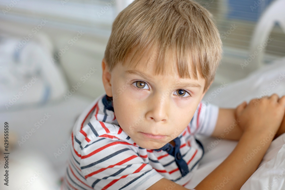 Little preschool child in hospital, with pupil dilation for medical exam after eye drops, after accident Little preschool child in hospital, with pupil dilation for medical exam after eye drops, after accident