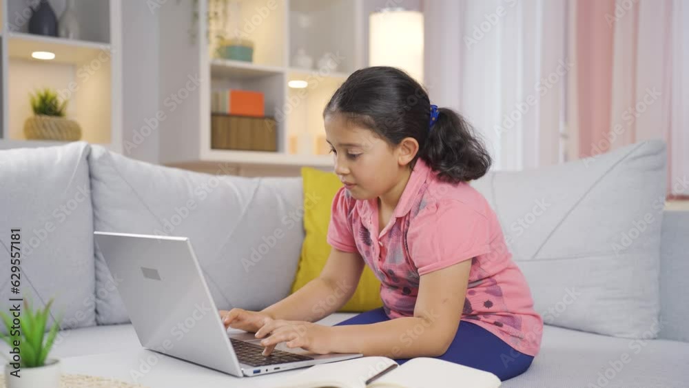 Girl child looking at laptop making positive gesture. Girl child looking at laptop making positive gesture.