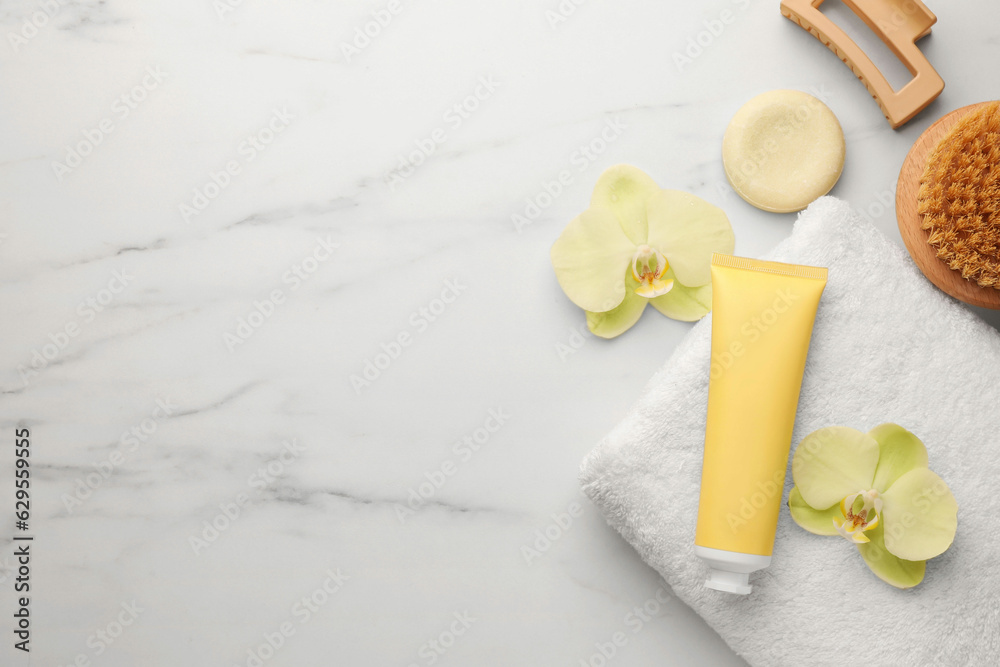 Flat lay composition with spa products and beautiful flowers on white marble table. Space for text Flat lay composition with spa products and beautiful flowers on white marble table. Space for text
