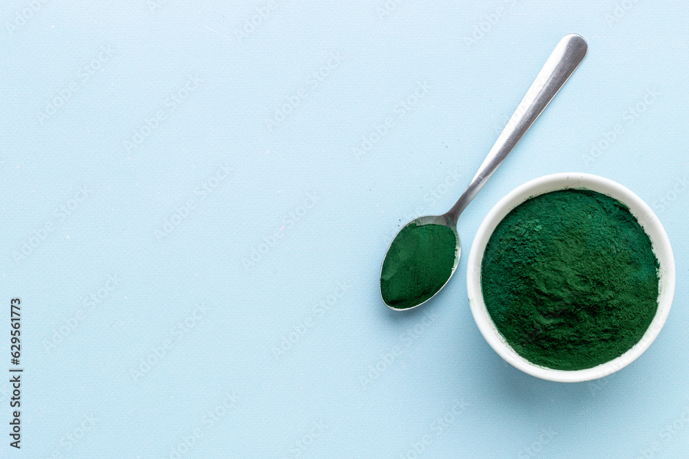 Spirulina algae powder in bowl and spoon, super food, top view Spirulina algae powder in bowl and spoon, super food, top view