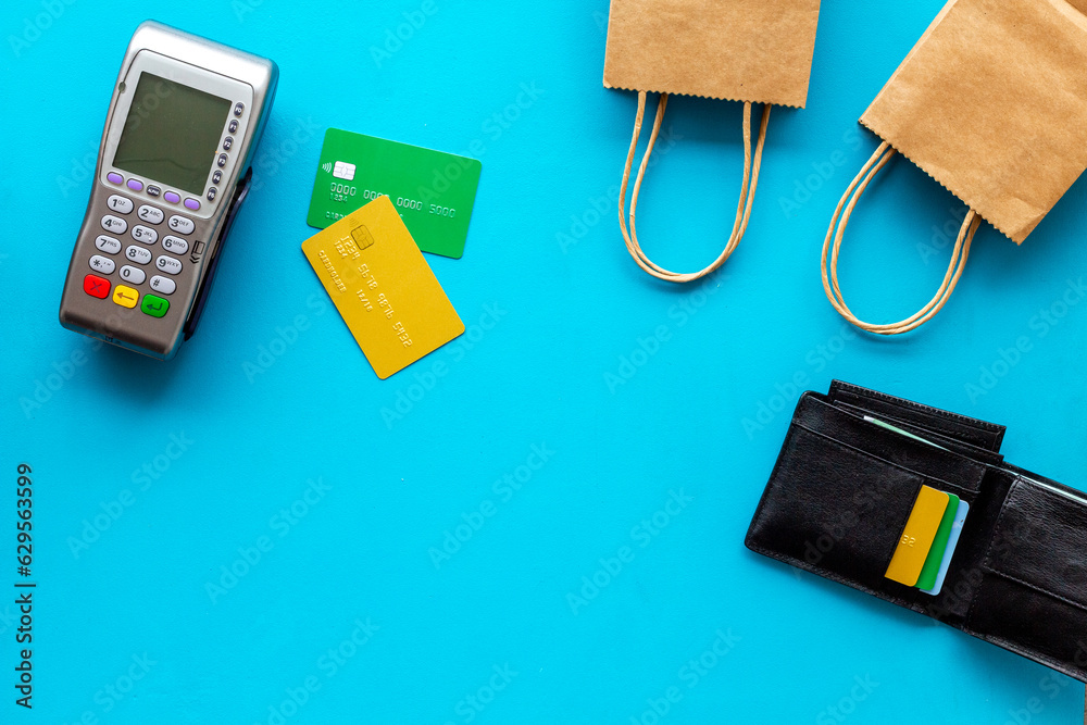 Fototapeta premium Retail and shopping concept. Pos payment terminal with credit cards and shopping bags