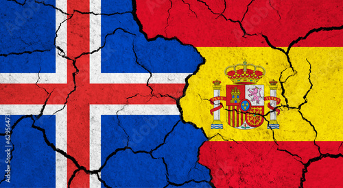 Flags of Iceland and Spain on cracked surface - politics, relationship concept
