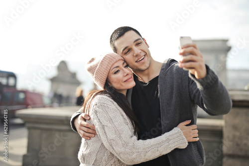 young couple takes a selfie in the city photo