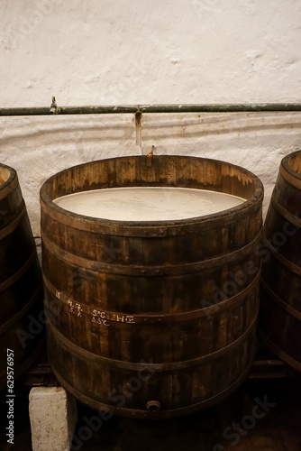 A wooden barrel full of fermenting beer.