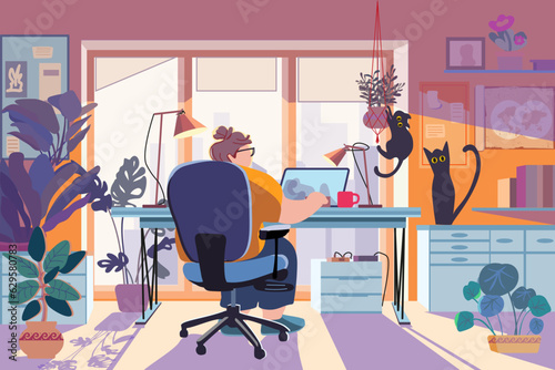 Fat woman working on a laptop while sitting at the table in a cozy interior