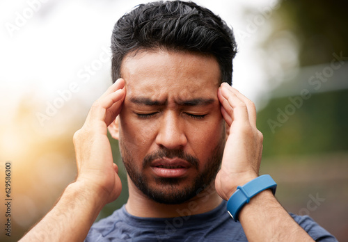 Face of sports man, headache and pain outdoor for injury, vertigo and tired of exercise problem. Sad asian athlete, sick runner and training with migraine, fatigue or stress of burnout for fitness