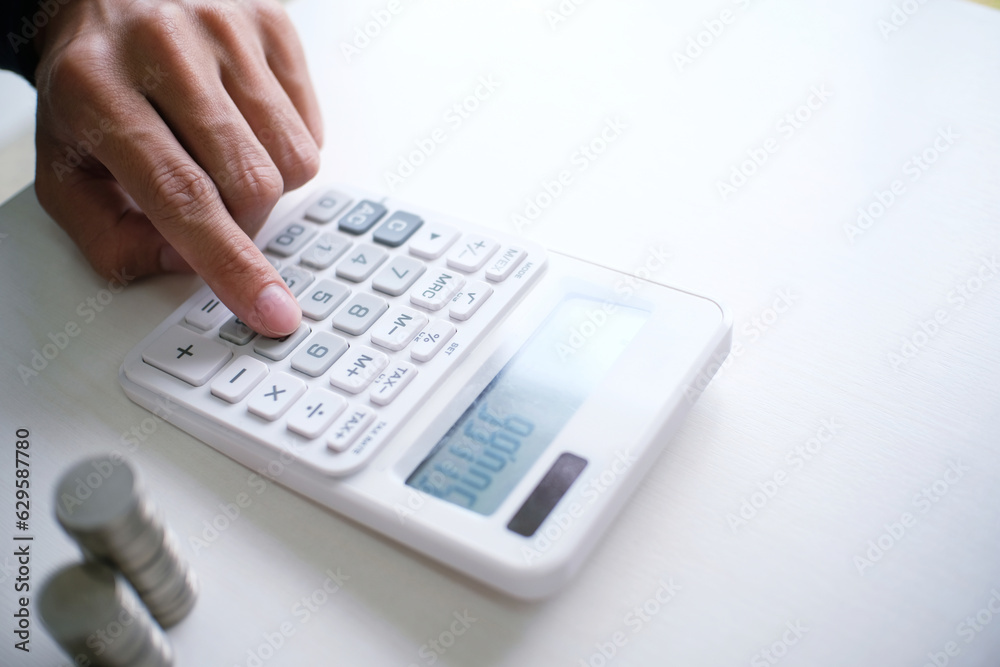 Accountant verify the business and saving money stacking gold coins with calculator. Accountancy Concept Accountant verify the business and saving money stacking gold coins with calculator. Accountancy Concept
