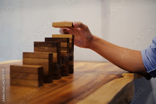 Planning risk and strategy in businessman gambling placing wooden block.Business concept for growth success process
