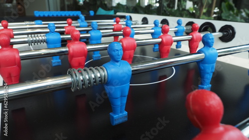 Football table or soccer table game with plastic player figurine. Mini Soccer game which famous in past and be collectable item for foosball lover. Play by two hand control each row of player figurine © gnepphoto