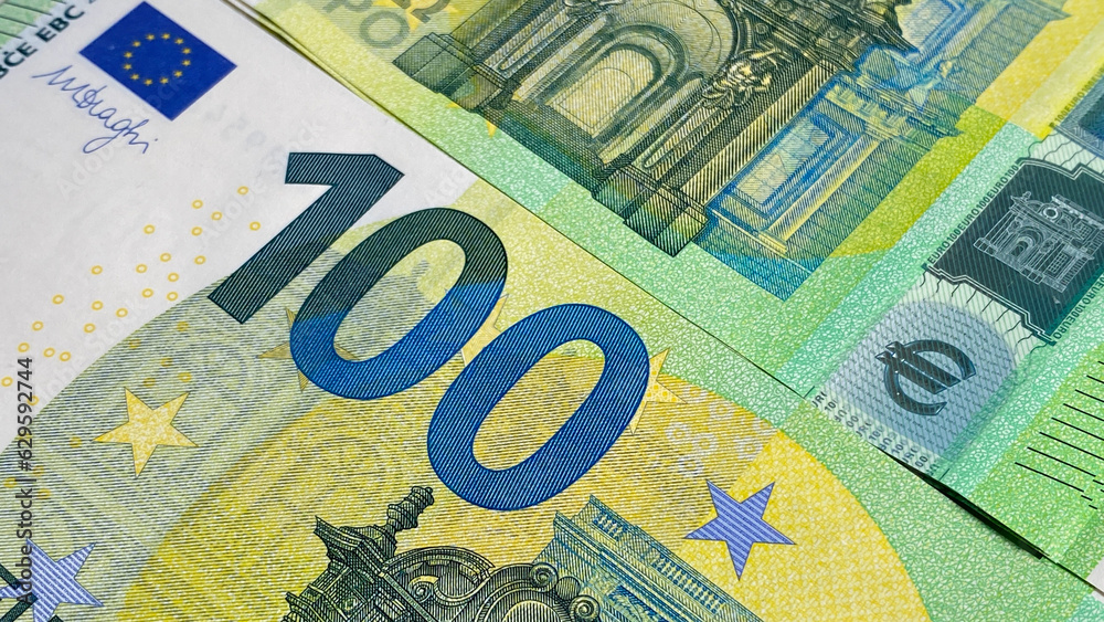 Close-up of part of a one hundred euro note. Single currency of the European Union. European currency. 100 euro. Cash banknotes. Financial business background concept. - obrazy, fototapety, plakaty 