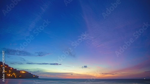 Time lapse The sunset sky is illuminated by colorful clouds .As the sun slowly sets, the clouds become ever more vibrant and beautiful..amazing sky of bright sunset in nature background. photo