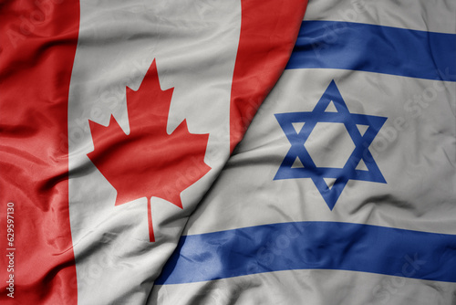 big waving realistic national colorful flag of canada and national flag of israel .
