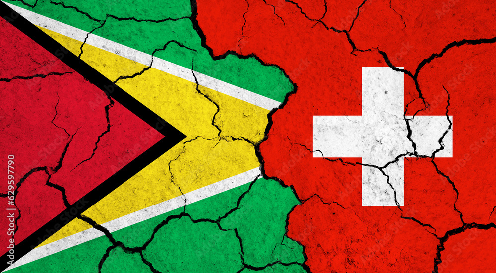 Flags of Guyana and Switzerland on cracked surface - politics, relationship concept