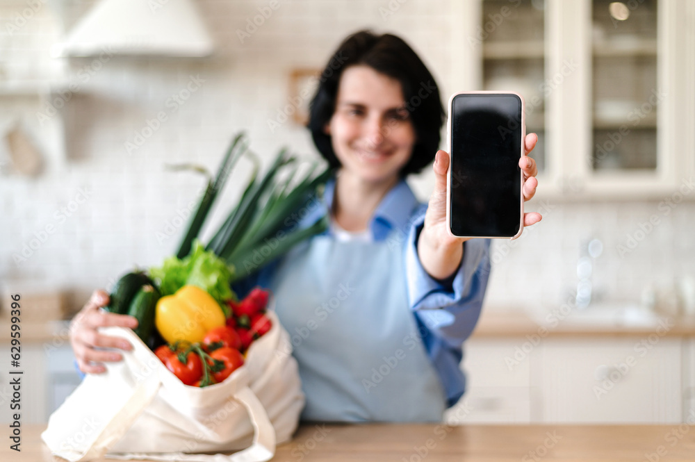 Selective focus on woman hand holding smartphone with empty screen Selective focus on woman hand holding smartphone with empty screen