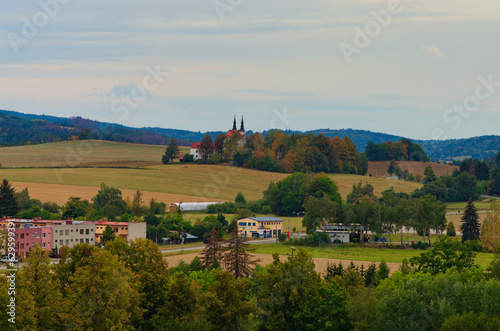 Typical aerial landscape view of the Czech Republic. Buildings with red tile roofs  agriculture fields and forest in the background. Small town in the Czech Republic. Travel and tourism concept