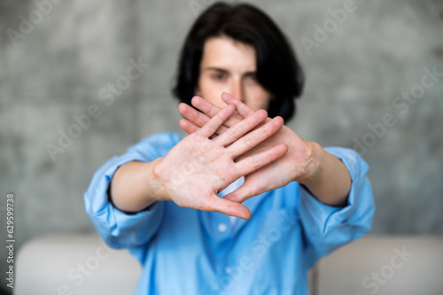 Selective focus on woman hands showing stop gesture photo