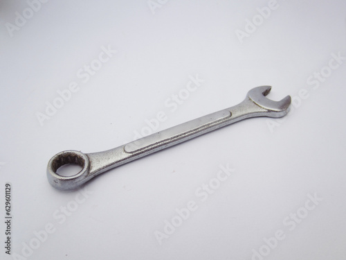close up silver metallic ring wrench made of metal for mechanic on white isolated background  © Randi