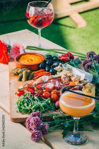 Mix of different snacks and appetizers on a wooden board