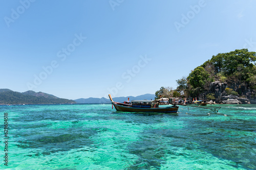 Wooden boat in emerald sea on summer during sunny day at Lipe Island